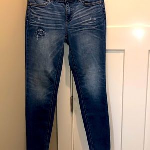 White House Black Market skinny ankle distressed jeans.